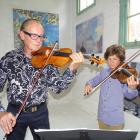 Michael Hill (81) plays the 1755 Guadagnini violin alongside grandson Jacob Jacques at the Thomas...