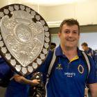 Otago captain Michael Collins brings the Ranfurly Shield with him through Dunedin Airport...