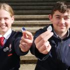 Kavanagh College pupils Anamika Jones (12) and Tom Restall (14) hold guitar picks cut from old Go...