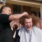 King's High School pupil Robbie Heller gets his hair shaved by Bloke barber Rewi Pomare at school...