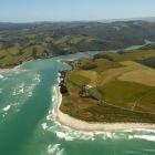 This photograph of Taieri Mouth, taken in 2016, shows a deeper water channel to the north, but...