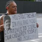 Alexandra man Tony Jarvis holds a placard outside the town’s Oranga Tamariki office describing...