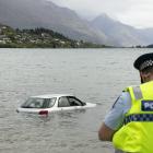 Police at Lake Wakatipu where a car was driven into the water. Photo: Matthew Mckew