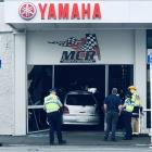 The vehicle crashes into the MCR shop front in Crawford St. Photo: Craig Baxter