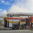 Smoke rises from a house in Ettrick St as firefighters respond to a blaze at the back of the...