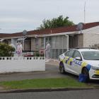 Police stand by as a scene examination is carried out on a Grace St property in Invercargill...