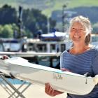Lesley Bolton smiles while holding the boat named after her at the Port Chalmers United Rowing...
