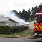 Smoke rises from the shed fire at a property in Kakanui. Photo: Gus Patterson