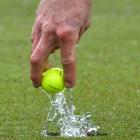 Leith Campion retrieves his ball from the hole during a rain-soaked semifinal of the Otago...