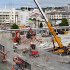 A crane is used to remove part of the former Wilson Parking building, which is being demolished...