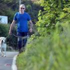 Kevin Braid and his dog Free walk on an uncut grass verge in Aramoana Rd, near Deborah Bay. PHOTO...