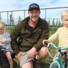 Mossburn dairy farmer and AG Proud founder Jason Checketts with his children Adelaide (2) and...