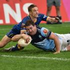 Otago halfback Kane Hammington is too late to stop Northland captain Jordan Olsen from scoring...