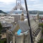 A complex section of structural scaffolding is lifted on to St Paul’s Cathedral, Dunedin, early...