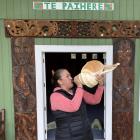 Araiteuru Marae manager Tania Williams sounds the putatara — a traditional Maori instrument made...