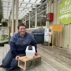 Open Valley Urban Ecosanctuary community engagement co-ordinator Clare Cross shows a couple of...