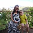 Queenstown resident Peggy Hieronymus clutches a picture of her stranded daugther, Xavion, 11,...