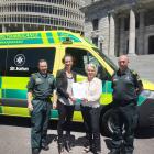 Pauline Latta (second left), of Mosgiel, hands her petition to Taieri MP Ingrid Leary, flanked by...