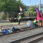 Climate change protesters, some locked to tracks, prevent a northbound coal train from moving...