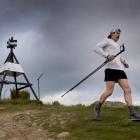 Chris Bisley starts back down Mt Cargill shortly after dawn yesterday during his record-breaking...