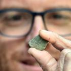 Associate Prof James Scott, of the University of Otago geology department, examines a small piece...