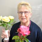 Otago Rose Society double Champion of Champions winner Wilma Graham holds her two champion roses,...