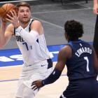 Dallas Mavericks' Luka Doncic  takes a shot against the Minnesota Timberwolves' Anthony Edwards...