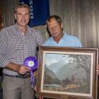 PGG Wrightson’s national velvet manager Tony Cochrane (left) presents Greg Oliver, of Palmerston,...