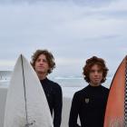 Friends Luke Rogers (16, left) and Kahu Kaan (15), both of Dunedin, head out for a surf at St...
