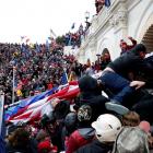 Protesters storm into the US Capitol during clashes with police in Washington last week. Photo:...