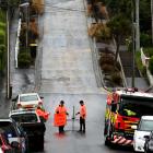 Firefighters cordoned off Baldwin St, in Dunedin, yesterday 
...