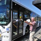 Dunedin Tramways Union delegate Alan Savell shows how a bus is unable to fit in a Macandrew Rd...