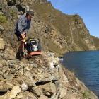 Jake Schofield, of Timaru, uses a rock crusher on the Cromwell Gorge cycle trail. 