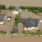 A farmhouse surrounded by floodwater from the Mataura River, upstream from Gore. PHOTO:STEPHEN...