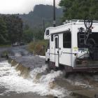 A campervan crosses the Silverstream ford after leaving the Whare Flat Folk Festival at the...