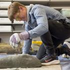 Waitara High School pupil Joseph Hill, of Taranaki, makes a stone tool at the University of Otago...