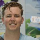 University of Otago Summer School student Thomas Jensen is issued with his ID card as the latest...