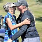 Maddie May (right), of Christchurch, is congratulated by her caddy Pip Idour, of Dunedin, after...