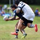 Otago Boys’ High School team member Jonah Aoina tries to take down Otago Islanders player Kalolo...