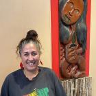 Araiteuru Marae manager Tania Williams, shown here in the meeting house with a carved depiction...