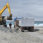 Contractors were criticised by beach-goers yesterday as they removed sand from Tomahawk Beach...