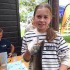 Sarah Dougherty (12), of Wanaka, holds the 716g brown trout that did not get away. PHOTO: KERRIE...