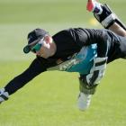 Black Caps wicketkeeper and captain Tom Latham gets his hand to the ball at training at the...