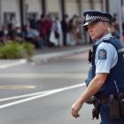 A police officer checks Dunedin’s bus hub area yesterday afternoon. PHOTO: PETER MCINTOSH
