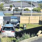 A silver car crashed through Lisa Lindon’s fence and landed on top of her ute on Monday afternoon...
