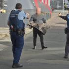 A man is subdued by police armed with Tasers and a firearm after he smashed up the Dunedin City...