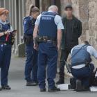 Dunedin police officers search a man’s bag in Princes St after an alleged attempt to steal...