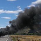 A car is engulfed in flames on the Lindis Pass in a black spot for cellphone coverage. PHOTO:...