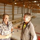 Robert Kvick (left) and John Campbell work on the new indoor curling rink in Alexandra, which is...