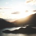 The sun sets behind Junction Island in Lake Benmore, where work to control wilding conifers is...